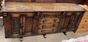 A 20th century oak sideboard with a rectangular top above four drawers and four cupboards ***PLEASE