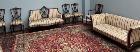 An Edwardian mahogany salon suite comprising a drop arm settee, two seater settee,