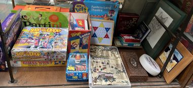 A collection of boxed games including Guess Who, Partini, Shop Til You Drop, Yes No,