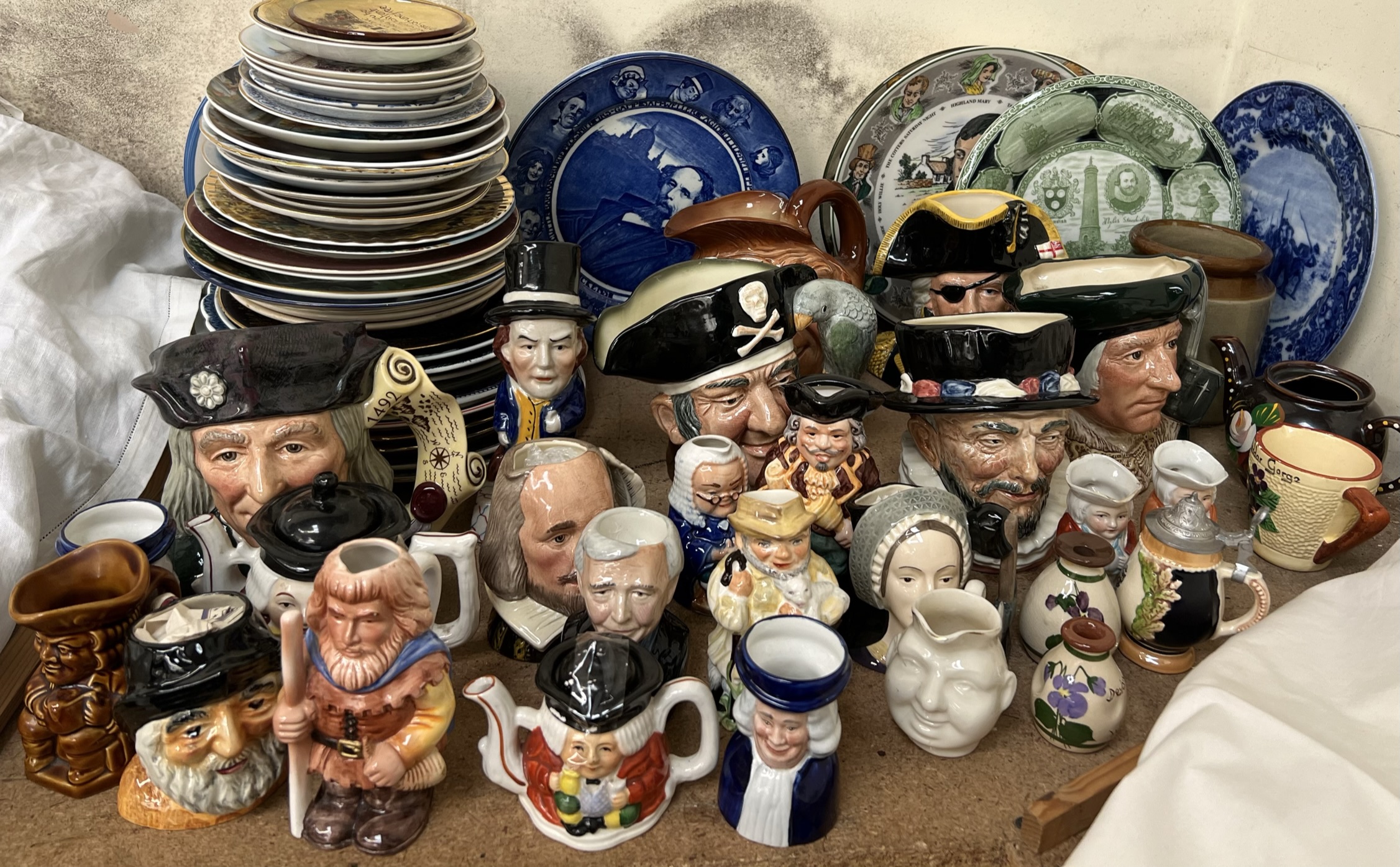 A collection of Royal Doulton character jugs including Christopher Columbus, Shakespeare,