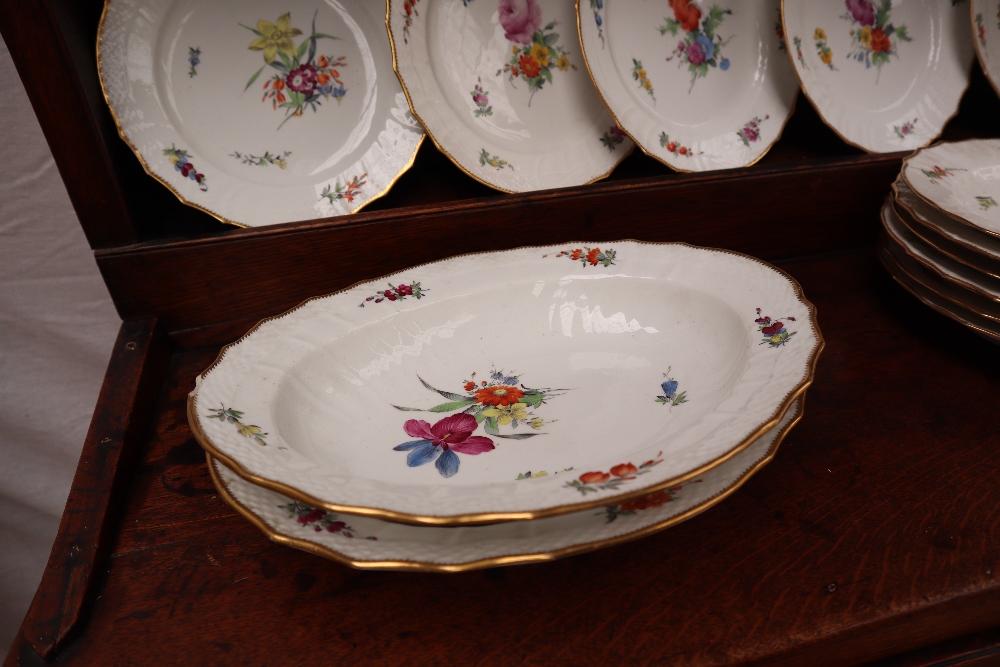 A 19th century Copenhagen porcelain part dinner set painted with garden flowers to a basket weave - Image 17 of 19