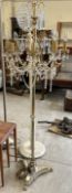 A brass chandelier standard lamp with eight arms and lustre drops