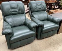 A pair of green leather La-Z-Boy reclining armchairs