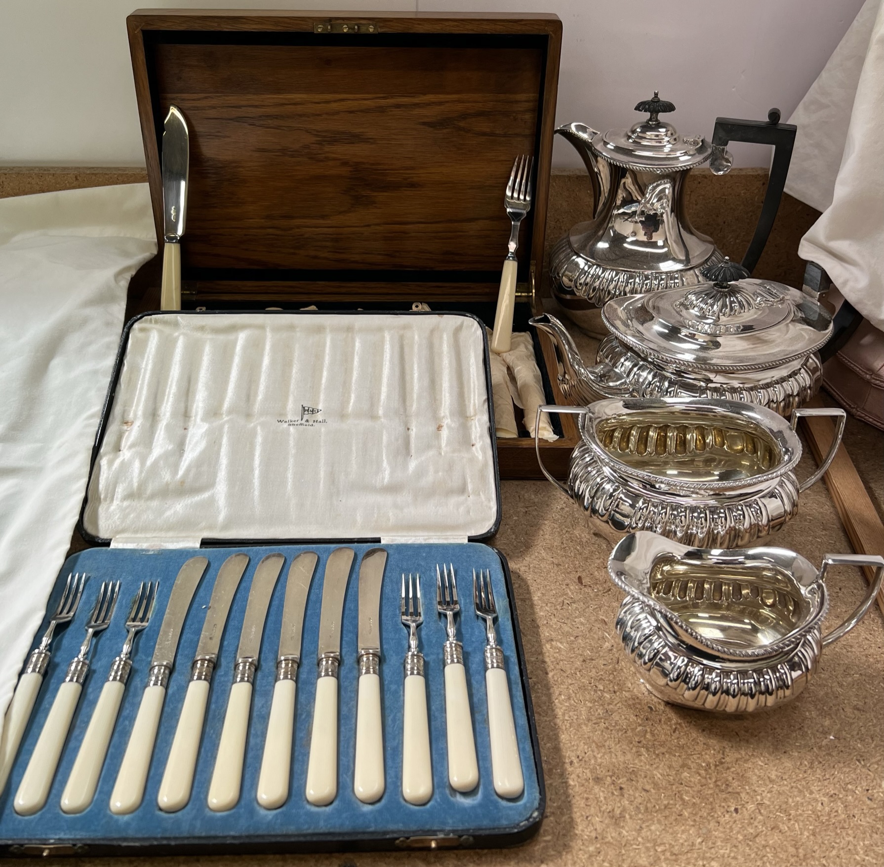 An electroplated four piece tea set together with cased flatwares