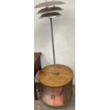 A mid 20th century standard lamp with cabinet base of circular form,