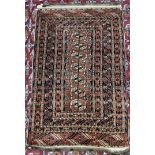 A Persian rug with a red ground, a central panel of seven guls and multiple guard stripes,