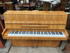 A Rogers walnut upright piano, metal framed, overstrung,