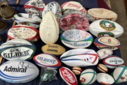 A collection of assorted signed rugby balls