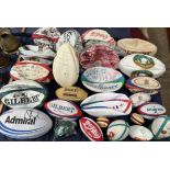 A collection of assorted signed rugby balls