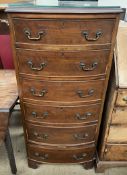 A reproduction mahogany chest of D shape with six graduated drawers