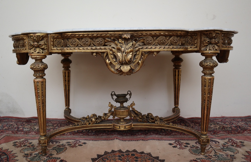 A French carved giltwood and gesso centre table with a shaped white marble top,