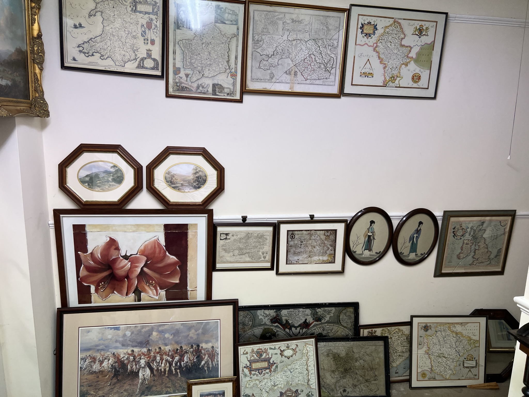 A collection of reproduction maps together with an oak framed wall mirror,