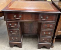 A reproduction mahogany kneehole desk,