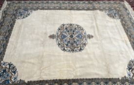 A Moroccan cream ground rug, with a central medallion and multiple guard stripes,