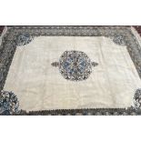 A Moroccan cream ground rug, with a central medallion and multiple guard stripes,