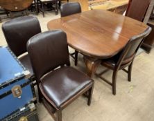 An Edwardian mahogany extending dining table and four chairs,