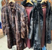 A fur coat together with two faux fur coats