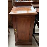 A mahogany pot cupboard with a square top above a single panelled door on a plinth base