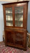 A 19th century mahogany standing corner cupboard with a glazed top and cupboard base on bracket