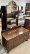A mahogany dressing table with a shaped mirror above two short and one long drawer on bracket feet