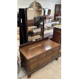 A mahogany dressing table with a shaped mirror above two short and one long drawer on bracket feet