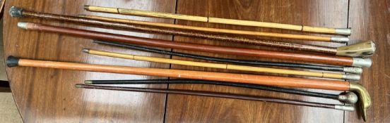 A Royal Welch Fusiliers swagger stick together with five other swagger sticks and walking sticks