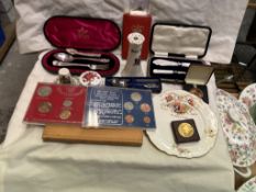 A silver spoon and fork christening set together with coins, commemoratives,