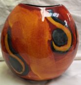 A Poole pottery vase of elliptical shape with an orange ground