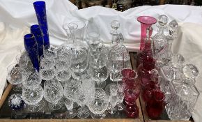 Cut glass decanters together with various drinking glasses, cranberry glass jugs,
