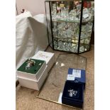 A Swarovski crystal secrets vase together with a Swarovski animals etc in a cabinet