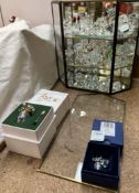 A Swarovski crystal secrets vase together with a Swarovski animals etc in a cabinet