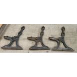 A set of three cast iron bench supports