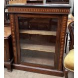 A Victorian rosewood bookcase with a rectangular top above a glazed door on a plinth base