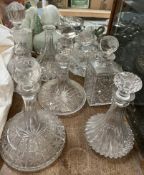 Cut glass ships decanters together with other glass decanters,