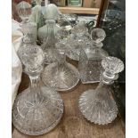 Cut glass ships decanters together with other glass decanters,