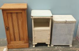 A loom laundry basket together with a wicker bedside cabinet and a limed oak bedside cabinet