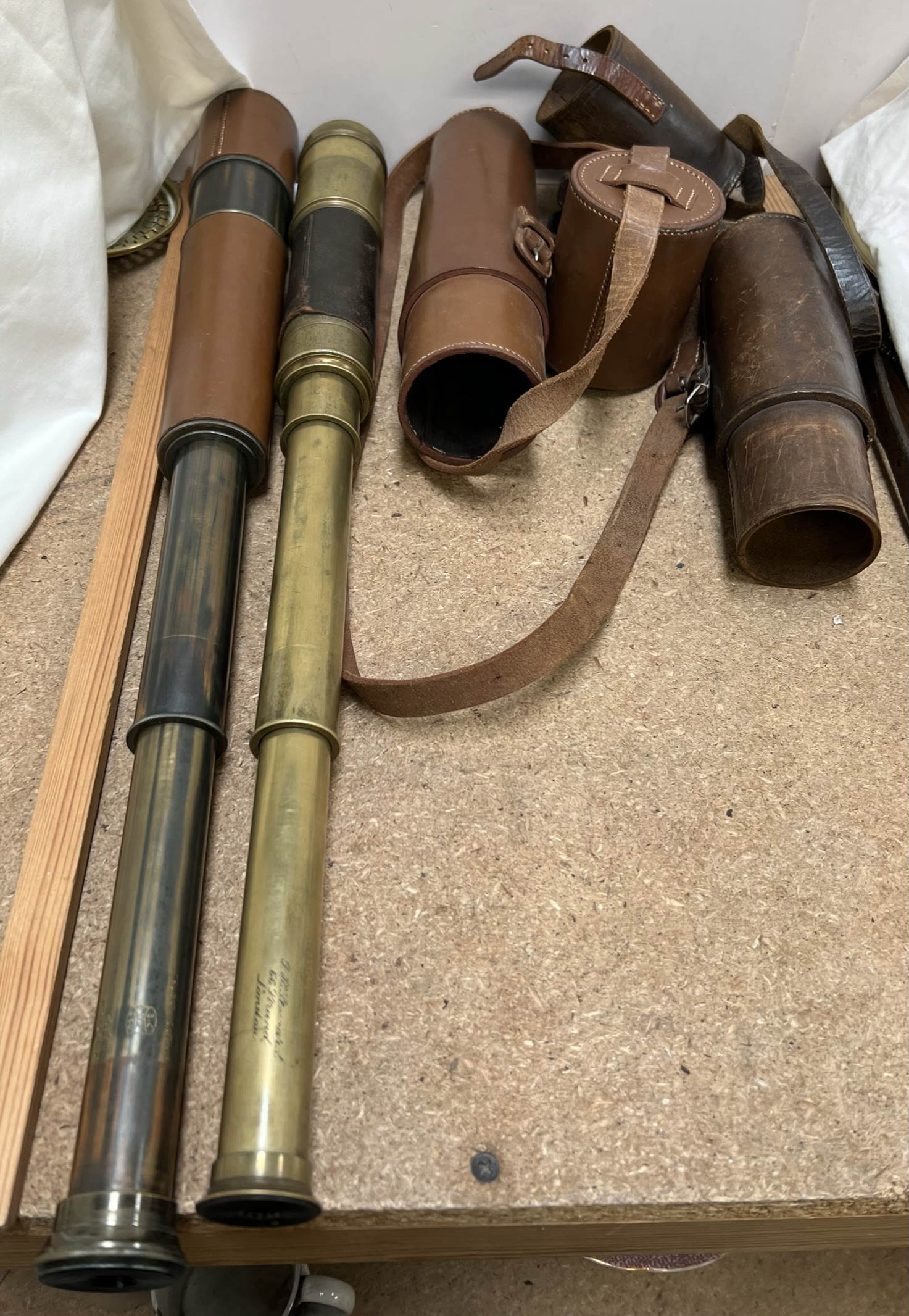 A J H Steward three drawer brass and leather telescope together with another telescope