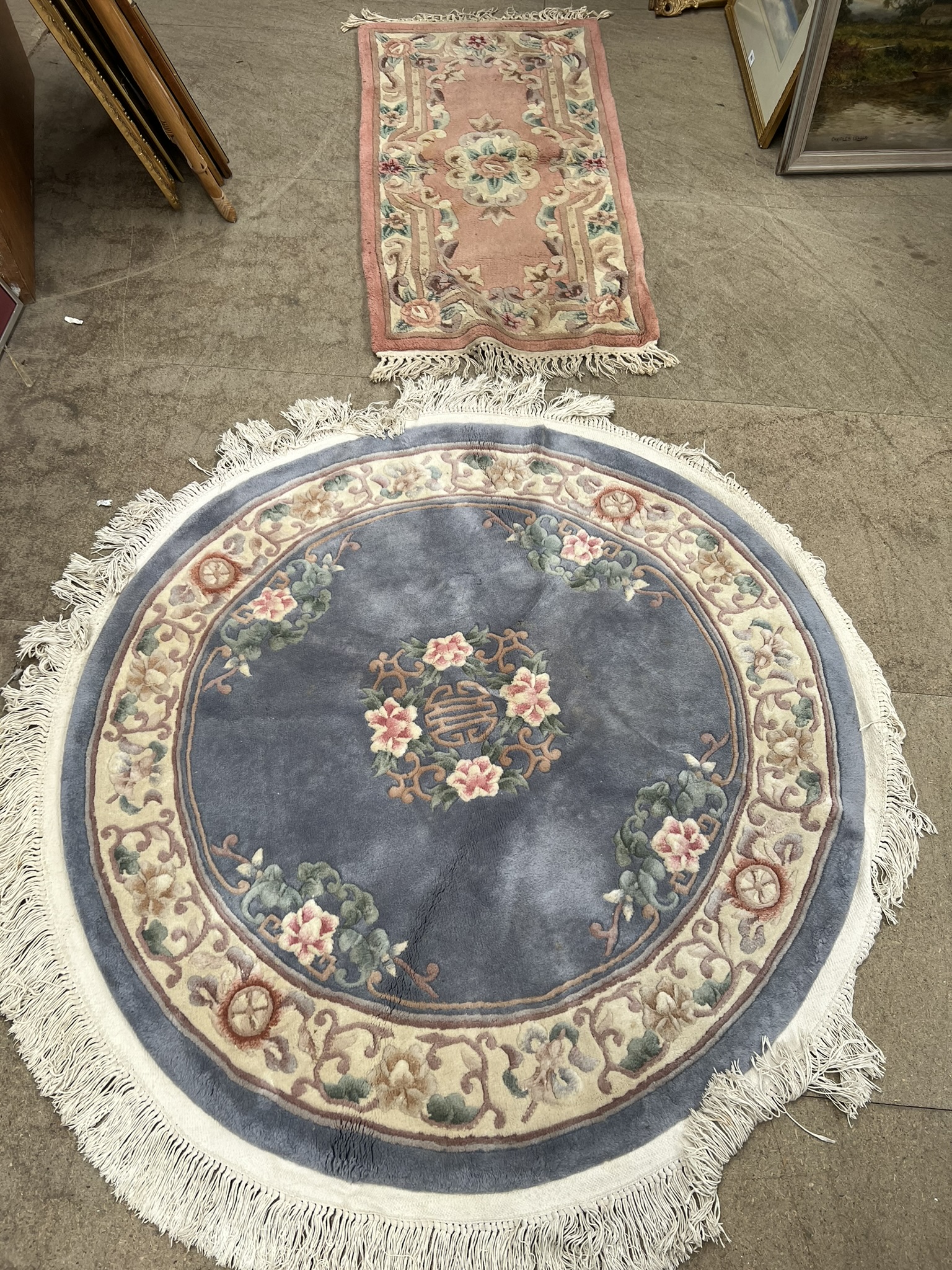 A blue ground Chinese rug of circular form together with another Chinese rug