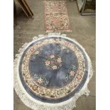 A blue ground Chinese rug of circular form together with another Chinese rug