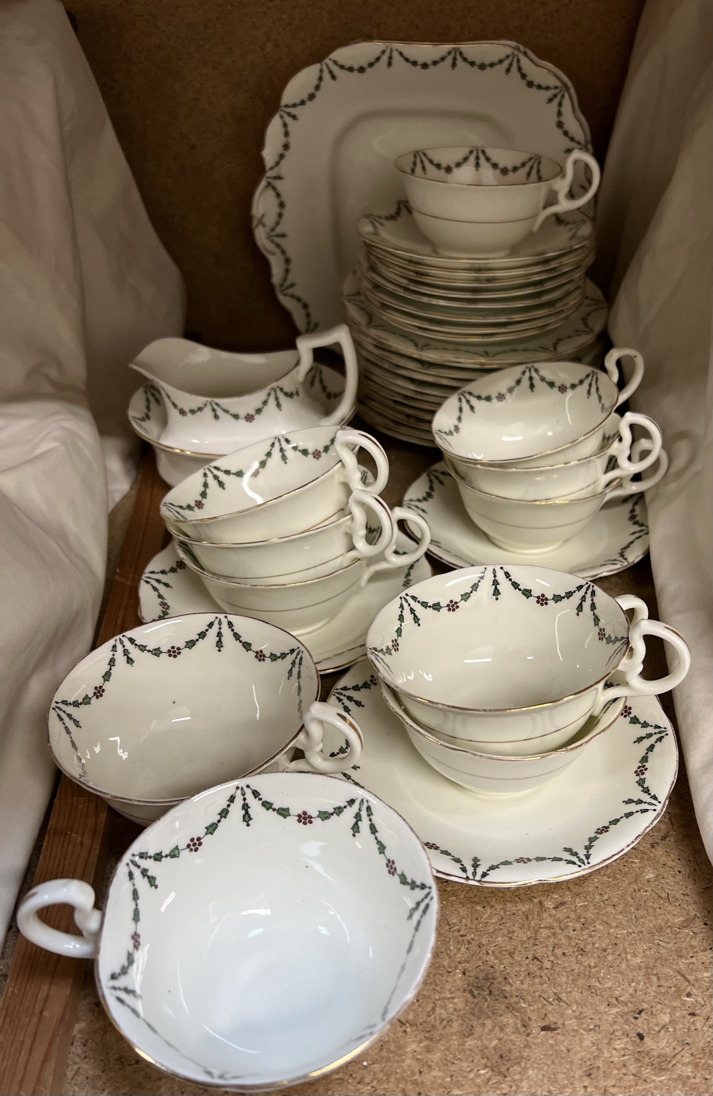 An Aynsley part tea set decorated with swags and berries