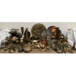 Brass candlesticks together with brass chargers, modern horse brasses, brass animals,