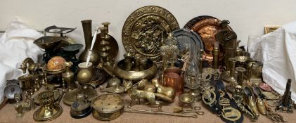 Brass candlesticks together with brass chargers, modern horse brasses, brass animals,