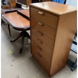 A tall teak chest with six drawers together with a reproduction mahogany extending dining table