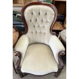 A Victorian mahogany spoonback library chair with button back upholstery on turned legs