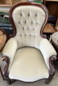 A Victorian mahogany spoonback library chair with button back upholstery on turned legs