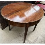A 19th century mahogany tea table the D shaped top with crossbanded decoration on square tapering