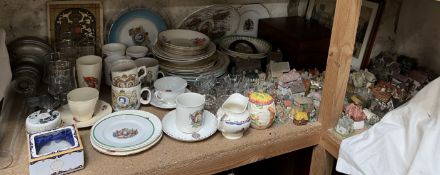 A collection of model cottages together with commemorative wares, decorative plates, oil lamp,