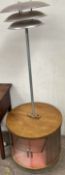 A mid 20th century standard lamp with cabinet base of circular form,