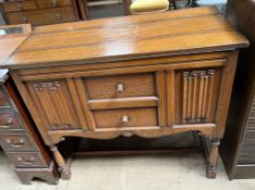 A 20th century oak cocktail cabinet, in the form of a side cabinet with linen fold panelled front,