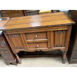 A 20th century oak cocktail cabinet, in the form of a side cabinet with linen fold panelled front,